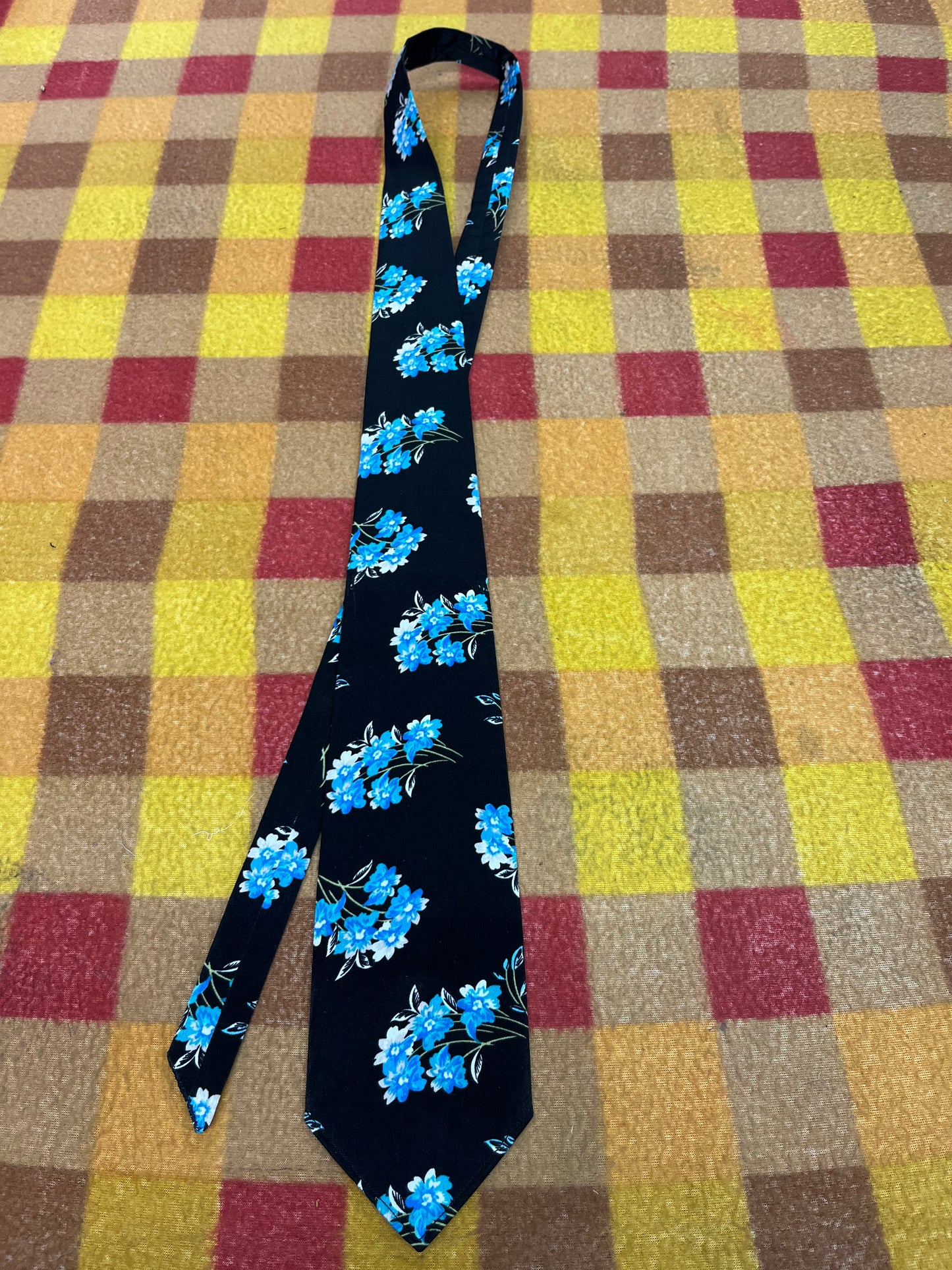 60” Necktie, 12x12” pocket square. Black/ blue flowers