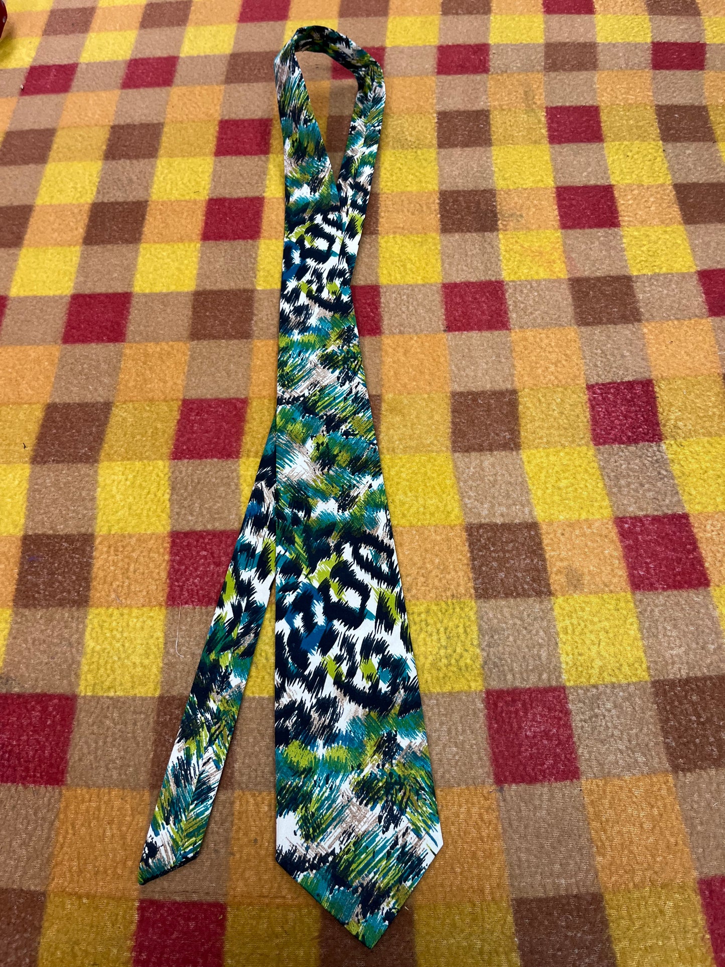 60” Necktie, 12x12” pocket square. Blue/green animal print
